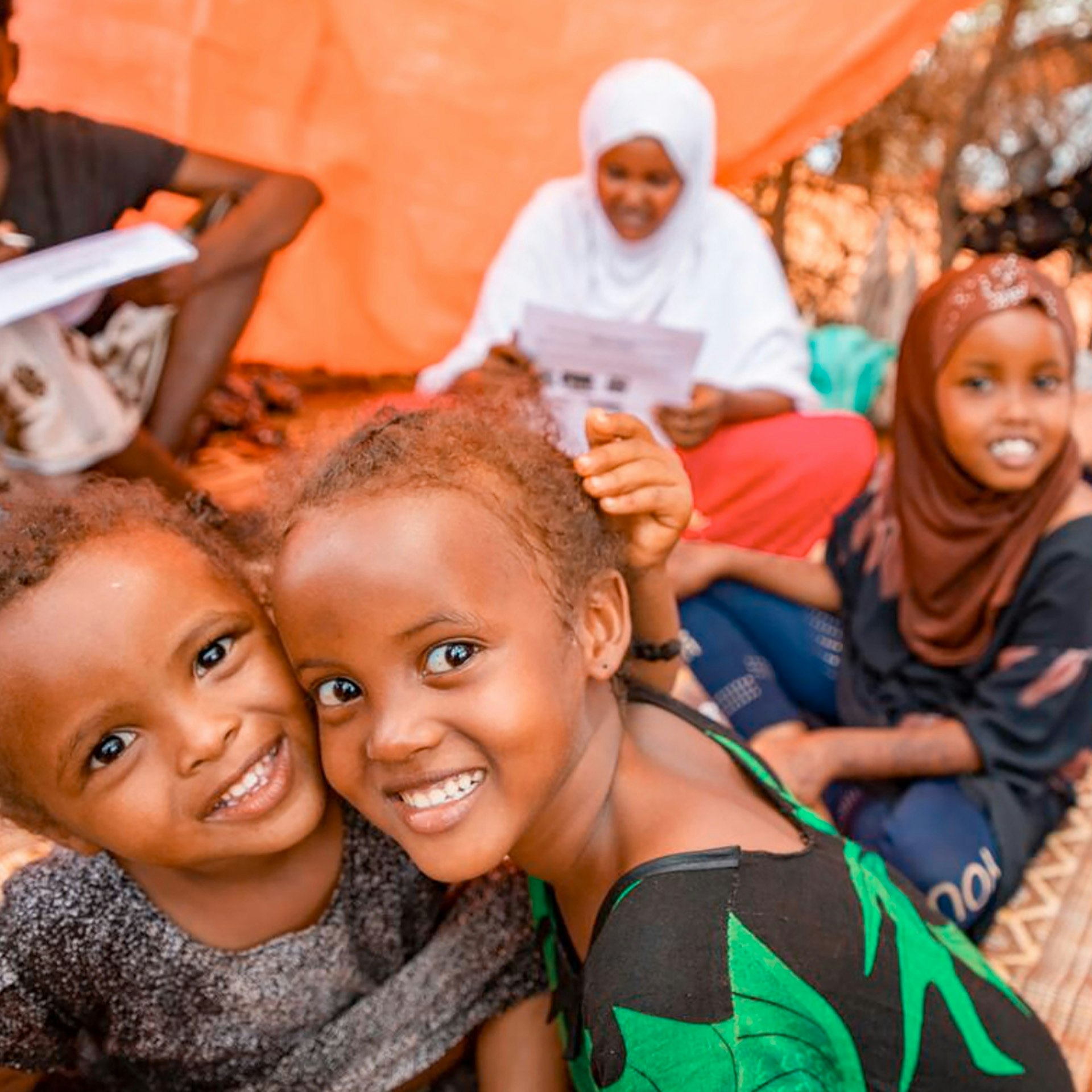 Girls smiling at the camera.